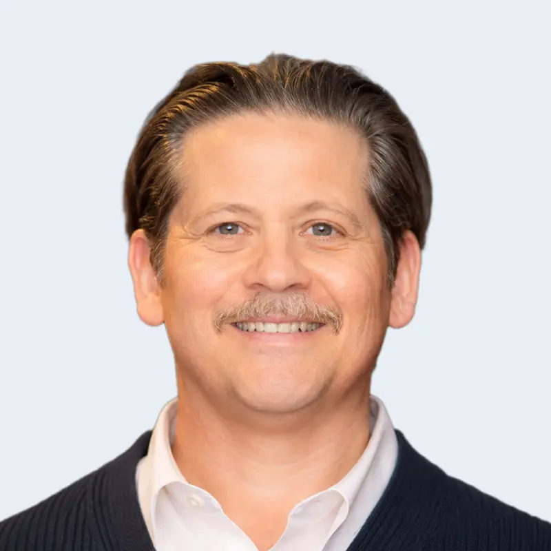 A headshot of Christian Janelli, VP of Product & Strategy at RainBarrel.